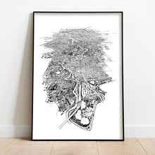 Load image into Gallery viewer, A black and white illustrated map of Melbourne City laid out on white paper, framed in a black frame, leaning on a white wall and wooden flooring.