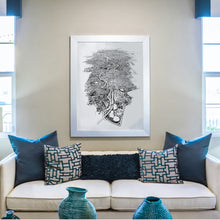Load image into Gallery viewer, A black and white illustrated map of Melbourne City laid out on white paper, framed in a white frame, hung on a cream wall between two windows and above a sofa.