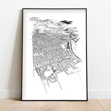 Load image into Gallery viewer, A black and white illustrated map of Palmerston North laid out on white paper, framed in a black frame, leaning on a white wall and wooden flooring.