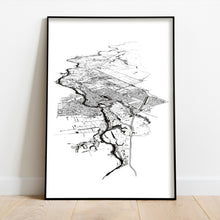 Load image into Gallery viewer, A black and white illustrated print of Cambridge laid out on white paper, framed in a black frame, leaning on a white wall and wooden flooring.