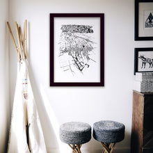Load image into Gallery viewer, A black and white illustrated print of Greytown laid out on white paper within a black frame hanging on a white wall above two stools and beside a teepee.