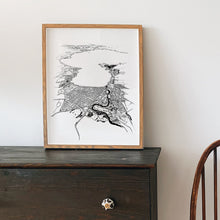 Load image into Gallery viewer, A black and white illustrated print of Taupō laid out on white paper within a wooden frame leaning against a white wall and sitting on a dark wooden console.