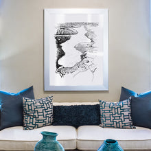 Load image into Gallery viewer, A black and white illustrated print of Te Anau laid out on white paper, framed in a white frame, hung on a cream wall above a sofa.