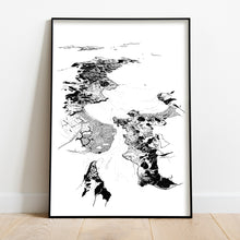 Load image into Gallery viewer, A black and white illustrated print of Whitianga laid out on white paper, framed in a black frame, leaning on a white wall and wooden flooring.