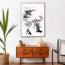 Load image into Gallery viewer, A black and white illustrated print of Whitianga laid out on white paper within a black frame hung on a white wall, above a wooden console with decor pieces.