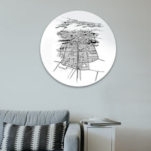 Load image into Gallery viewer, A round glass art piece with a black and white illustrated print of Auckland, mounted on a wall.