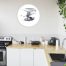 Load image into Gallery viewer, A round glass art piece with a black and white illustrated print of Mt Maunganui, mounted on a wall.