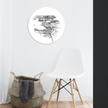 Load image into Gallery viewer, A round glass art piece with a black and white illustrated print of Wanaka, mounted on a wall.