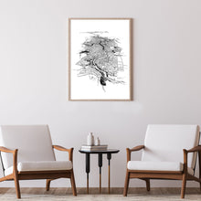 Load image into Gallery viewer, A black and white illustrated print of Hamilton, laid out on white paper within a wooden frame hung on a grey wall, two modern chairs and a coffee table situated below.