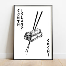 Load image into Gallery viewer, Black and white illustration of three spring rolls stacked together, held by a pair of chopsticks. The words "SOUTH ISLAND" are written vertically along the left side, and "SUSHI" is written vertically along the right side. The print is displayed in a black frame, positioned against a white wall on a wooden floor.