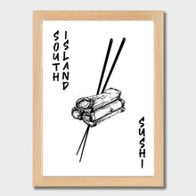 Load image into Gallery viewer, Black and white illustration of three spring rolls stacked together, held by a pair of chopsticks. The words "SOUTH ISLAND" are written vertically along the left side, and "SUSHI" is written vertically along the right side. The print is laid out on white paper within a light wooden frame against a white wall.